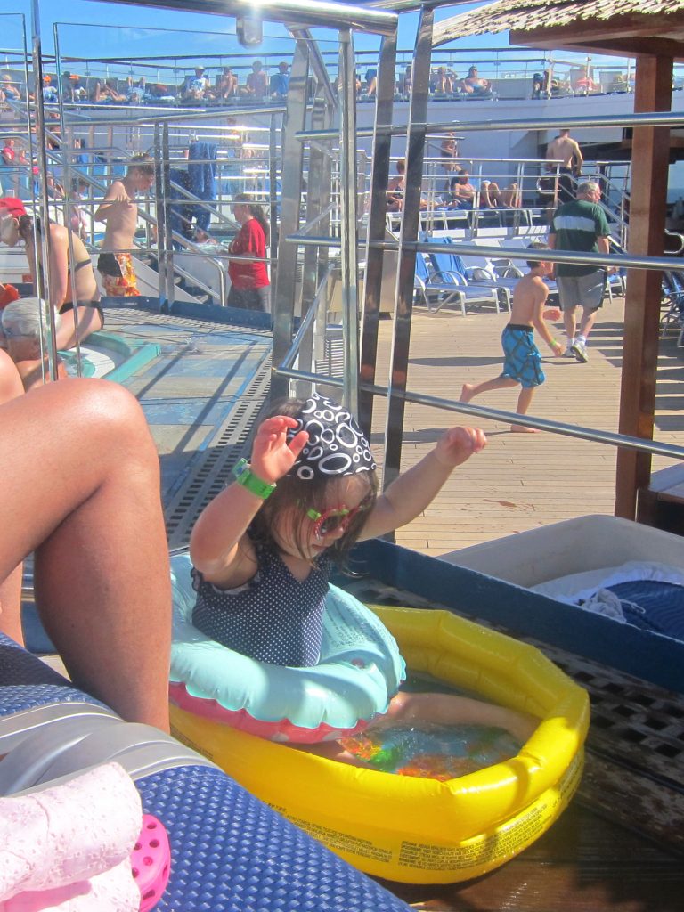 Toddler in a paddling pool on a cruise ship